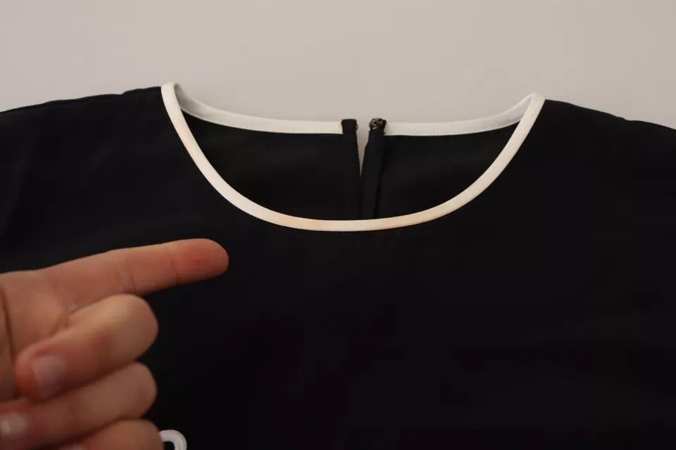 Débardeur sans manches noir en soie Dolce & Gabbana avec imprimé Eleganza, détail élégant et texture douce visible sur l'image.