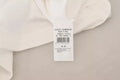 Pull léger Dolce & Gabbana blanc à rayures, manches courtes, style décontracté, porté sur un mannequin.