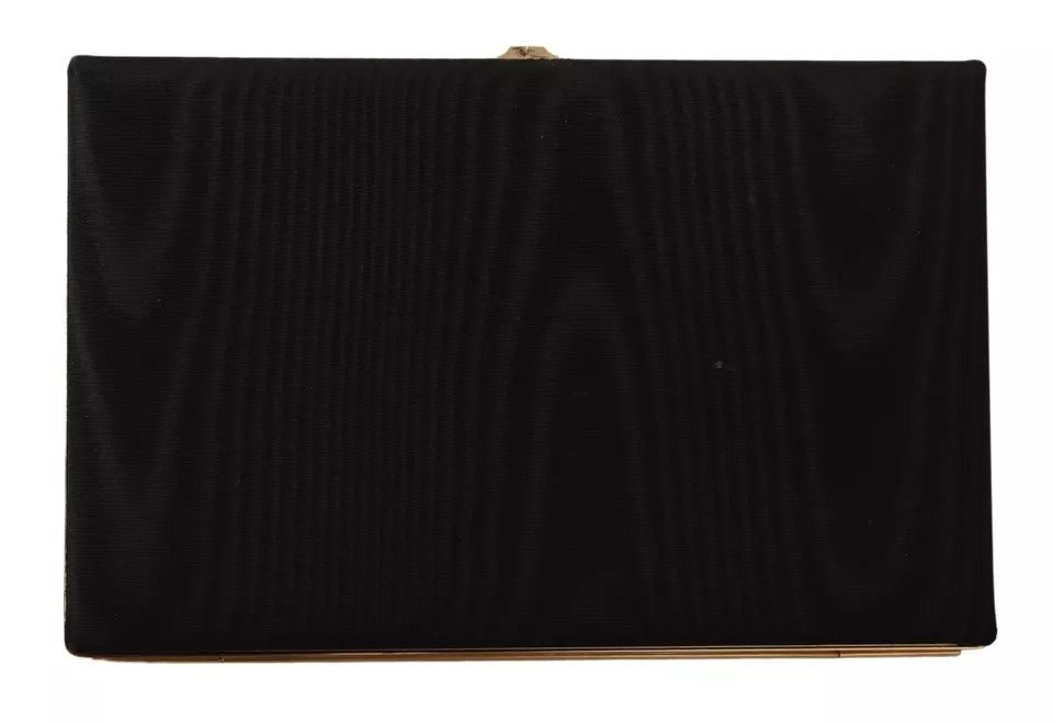 Sac pochette en soie noire Dolce & Gabbana avec cadre doré, élégant pour soirée et événements.