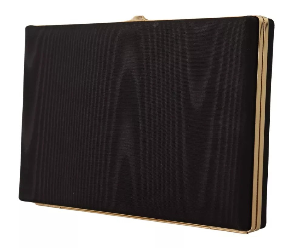 Sac pochette en soie noire Dolce & Gabbana avec cadre doré, idéal pour soirée et événements élégants.