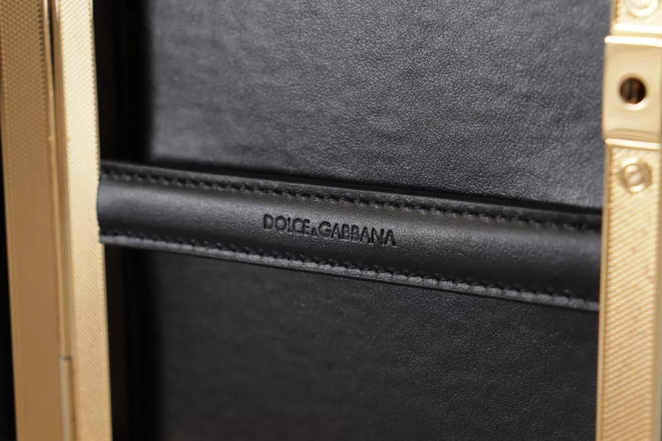 Sac clutch en soie noire Dolce & Gabbana avec cadre doré, parfait pour soirée et événements élégants.