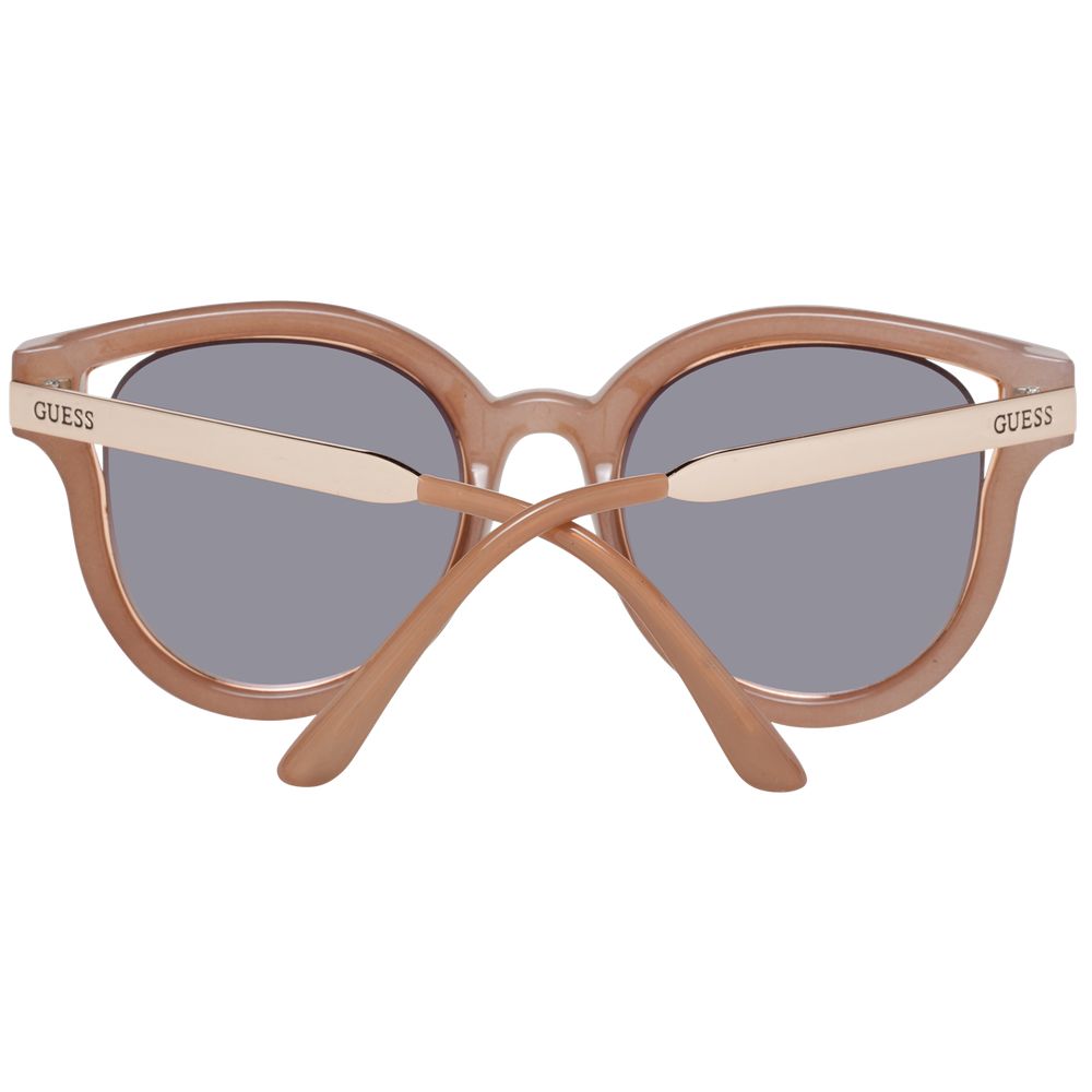 Lunettes de soleil Guess en métal et plastique marron avec monture élégante et modernes, pour un style tendance et sophistiqué.