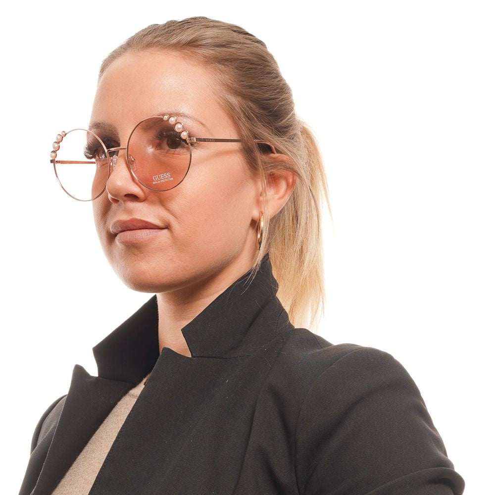 Lunettes de soleil en métal or rose Guess, design élégant avec monture fine et verres teintés pour un style sophistiqué.