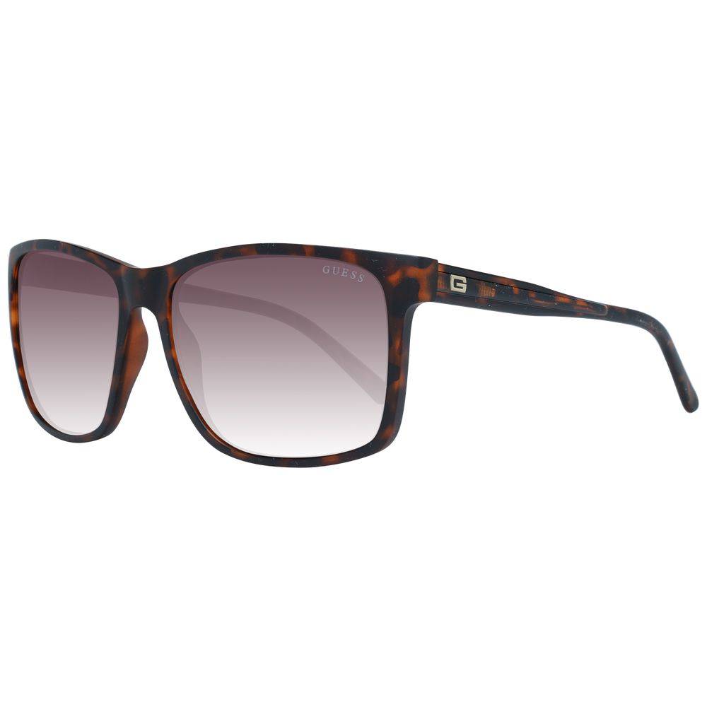 Lunettes de soleil en plastique brun de marque Guess, style tendance avec monture ronde et verres teintés.