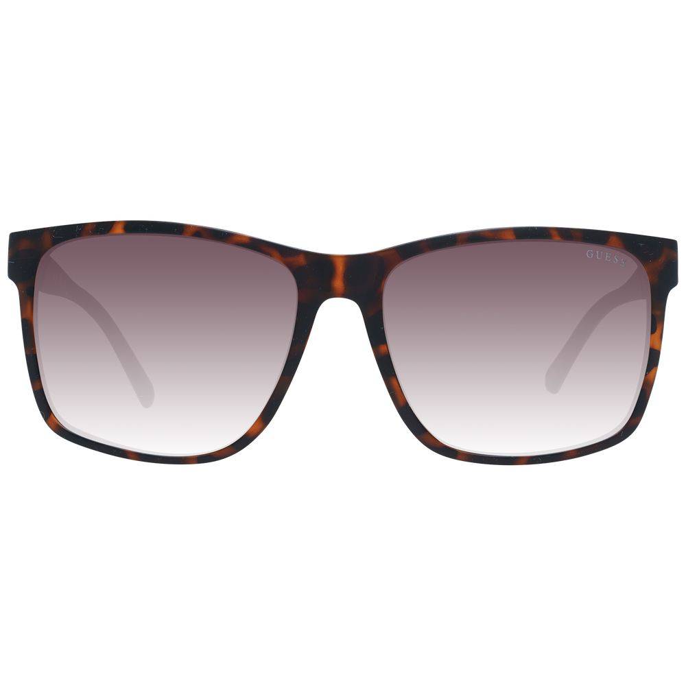 Lunettes de soleil en plastique marron de marque Guess, style tendance avec monture élégante, vue de face.