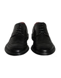 Chaussures formelles en cuir noir Dolce & Gabbana pour hommes, Oxford wingtip avec détails élégants et finition soignée.