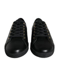 Chaussures sneakers classiques en cuir noir et or de Dolce & Gabbana, vue de face avec détails élégants.