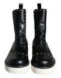 Bottes noires en cuir Dolce & Gabbana, mi-mollet, style combat, avec boucle et semelle en caoutchouc.