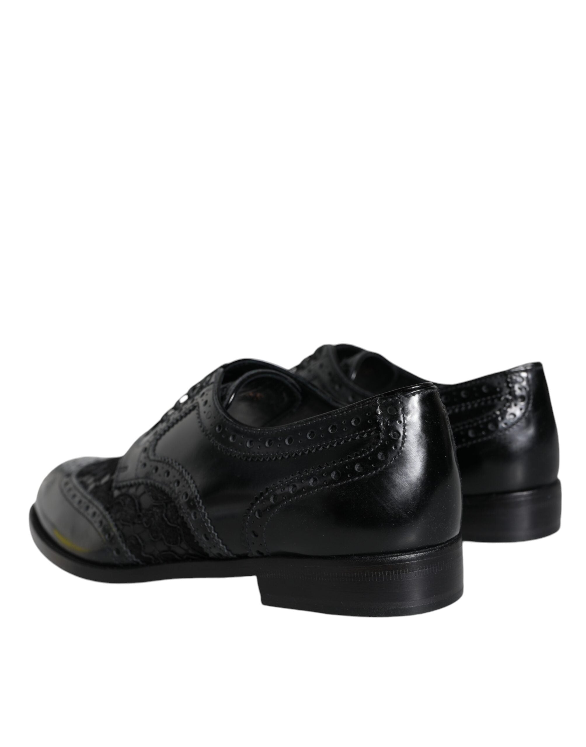 Chaussures formelles Dolce & Gabbana en cuir noir avec détails floraux en dentelle, élégantes et sophistiquées.