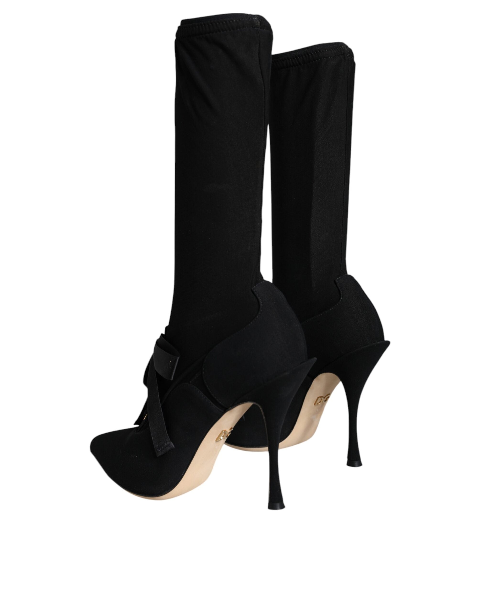 Chaussures Dolce & Gabbana, bottines noires à talons stilettos et mi-mollet, élégantes et sophistiquées, visibles en gros plan.