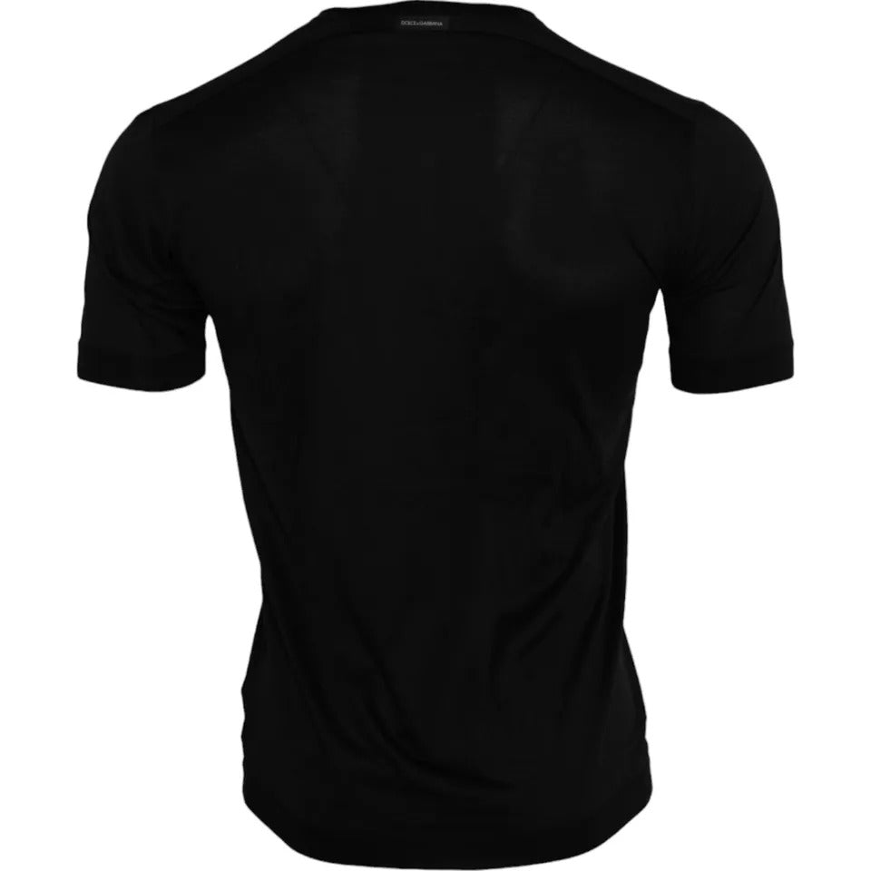 T-shirt noir en soie Dolce & Gabbana à col rond à manches courtes, élégante et fluide, vue de face.