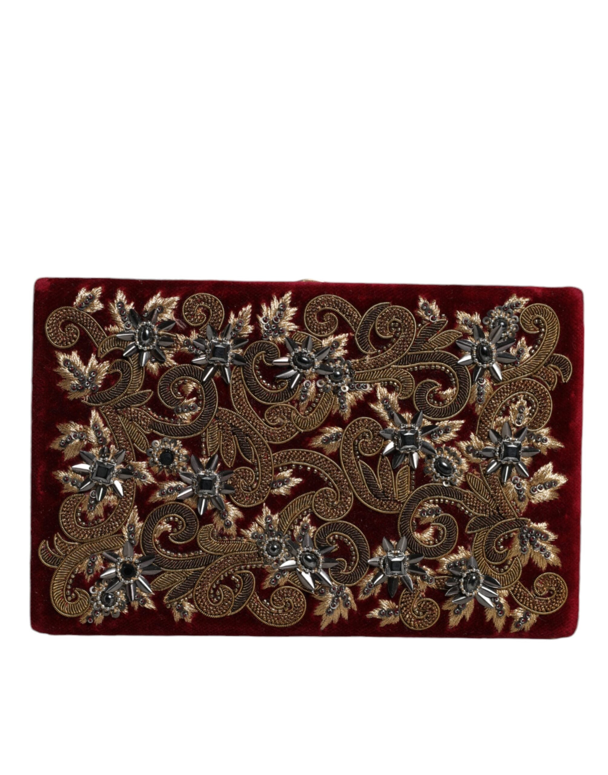 Sac pochette Dolce & Gabbana en velours rouge avec cadre en or, idéal pour soirée et événements élégants.