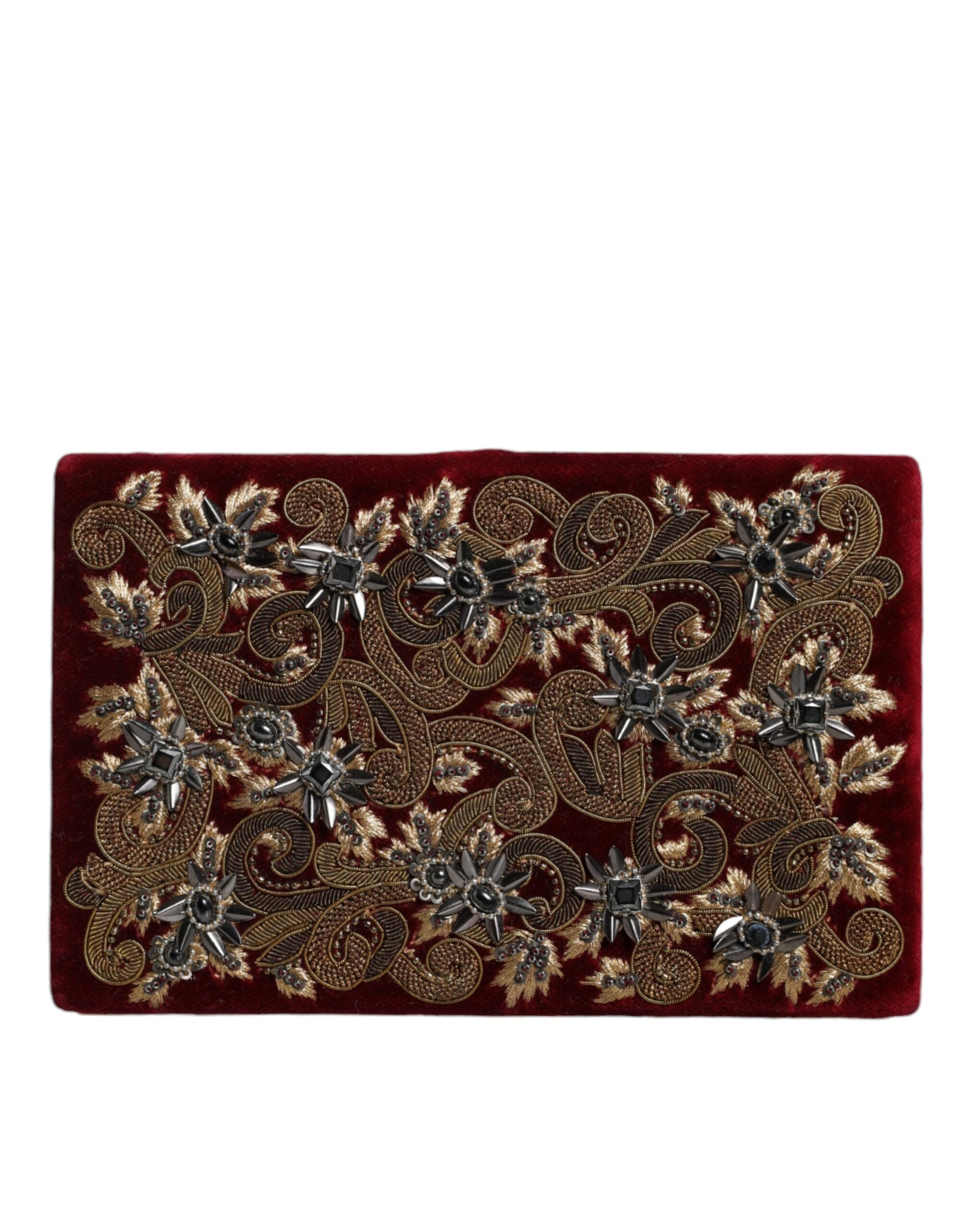 Sac clutch Dolce & Gabbana en velours rouge avec cadre doré, parfait pour soirée et événements élégants.