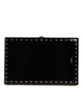 Sac clutch noir en cuir Dolce & Gabbana avec studs et cadre doré, pochette élégante pour soirée.