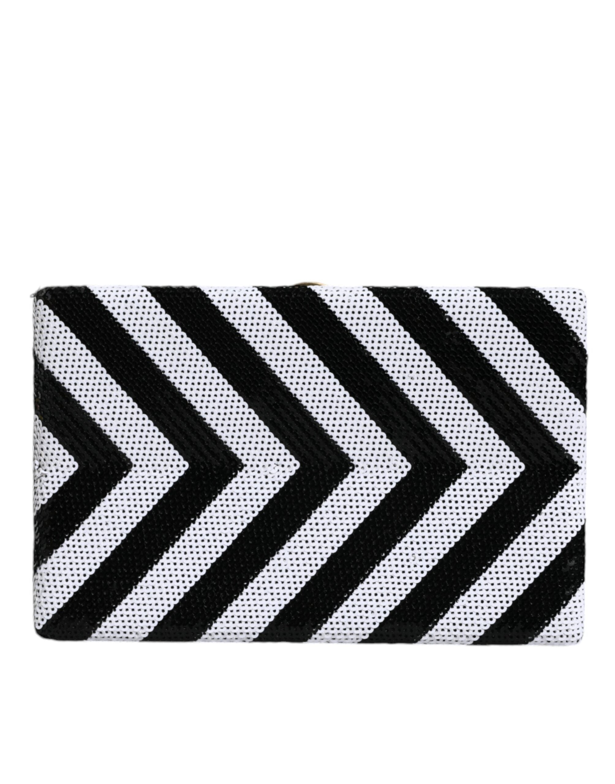 Sac pochette Dolce & Gabbana noir, blanc et or avec cadre doré, idéal pour soirée et fête, en cuir élégant.
