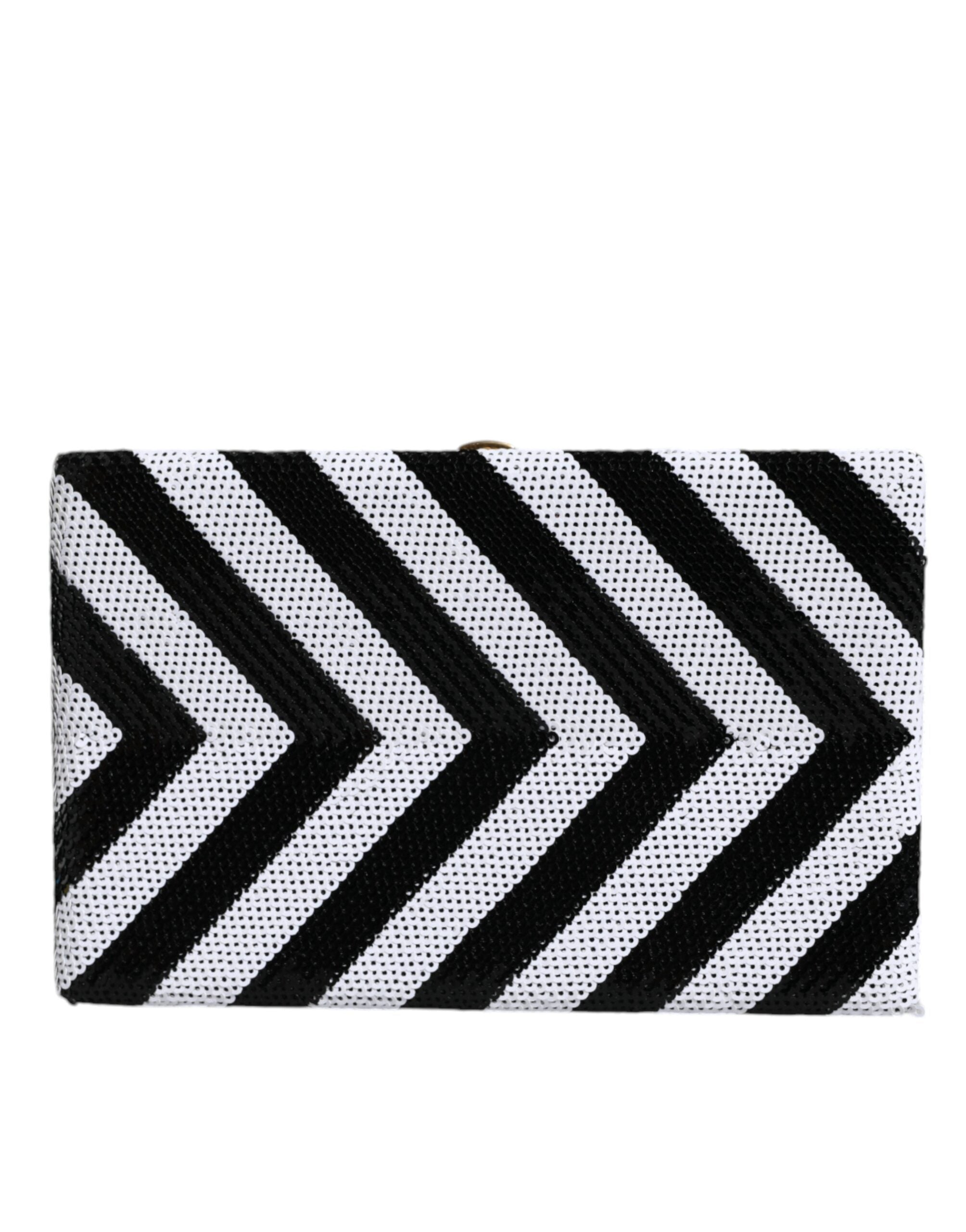 Sac pochette Dolce & Gabbana noir blanc avec cadre doré, sac de soirée élégant pour fête ou événement.