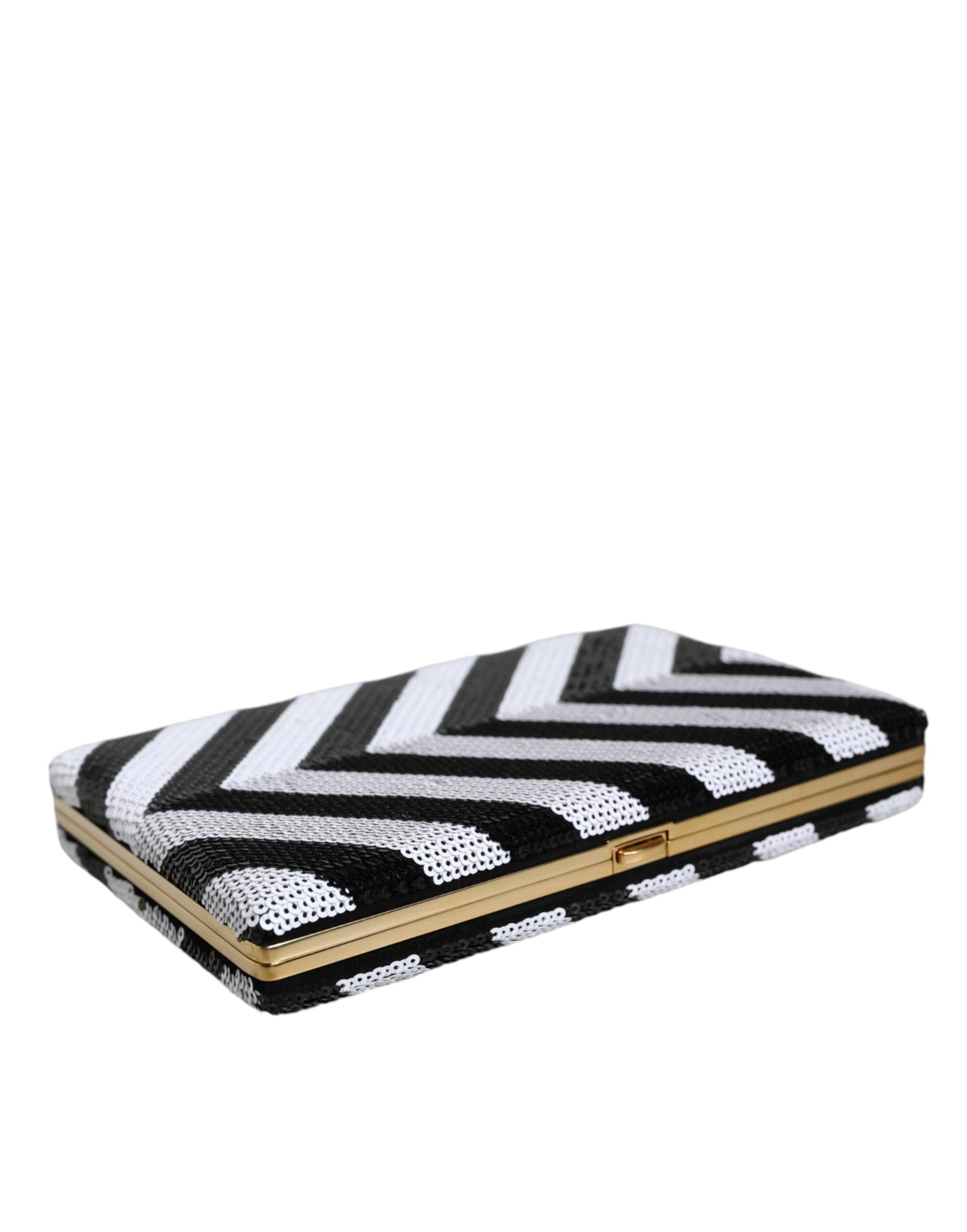 Sac pochette Dolce & Gabbana noir, blanc et or avec cadre métallique pour soirée et fête, élégant et sophistiqué.