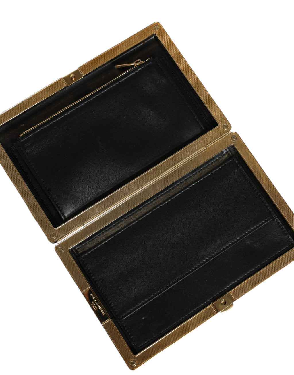 Sac clutch Dolce & Gabbana noir, blanc et or pour soirée, avec cadre élégant et design sophistiqué.
