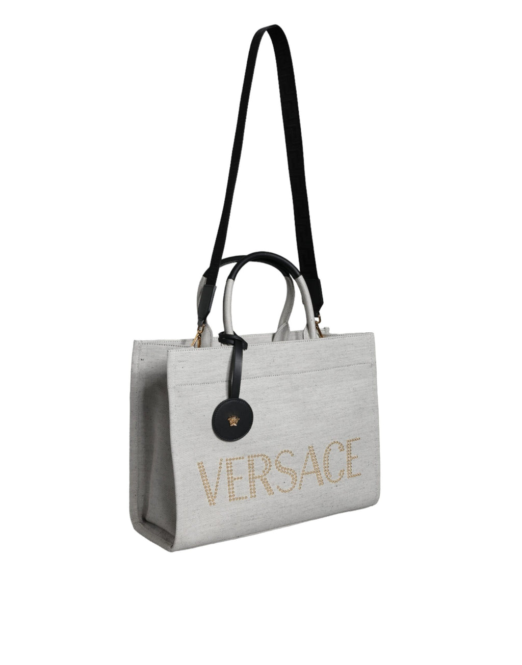 Sac cabas Versace blanc en toile et cuir avec logo, poignées torsadées et bandoulière pour un style élégant.