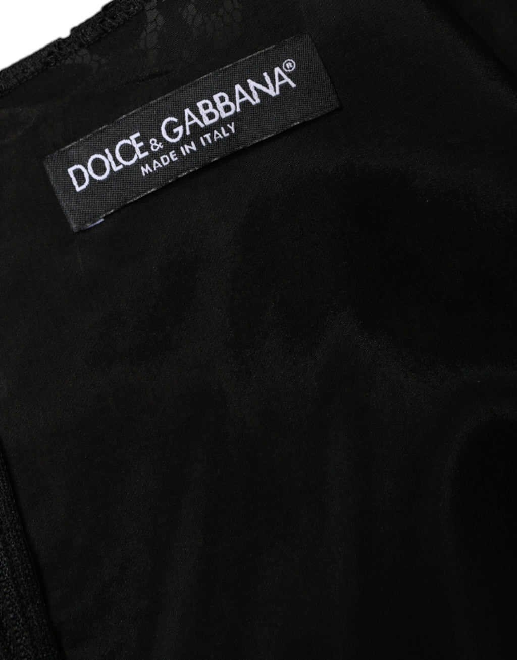 Robe courte noire en dentelle florale sans manches de Dolce & Gabbana, coupe ajustée et élégante.