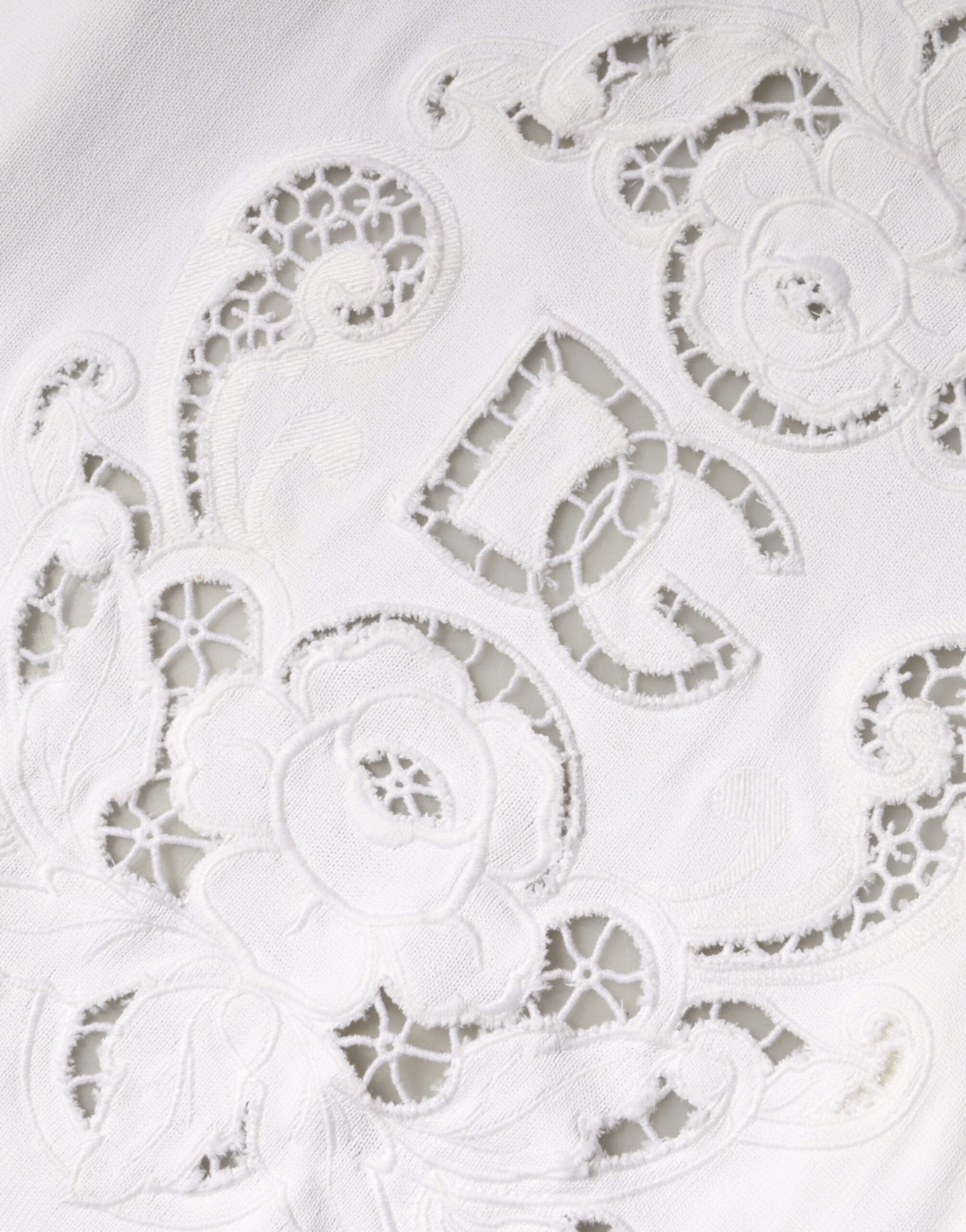 Cardigan Dolce & Gabbana en viscose blanche avec motifs floraux et découpes élégantes, porté sur un mannequin.