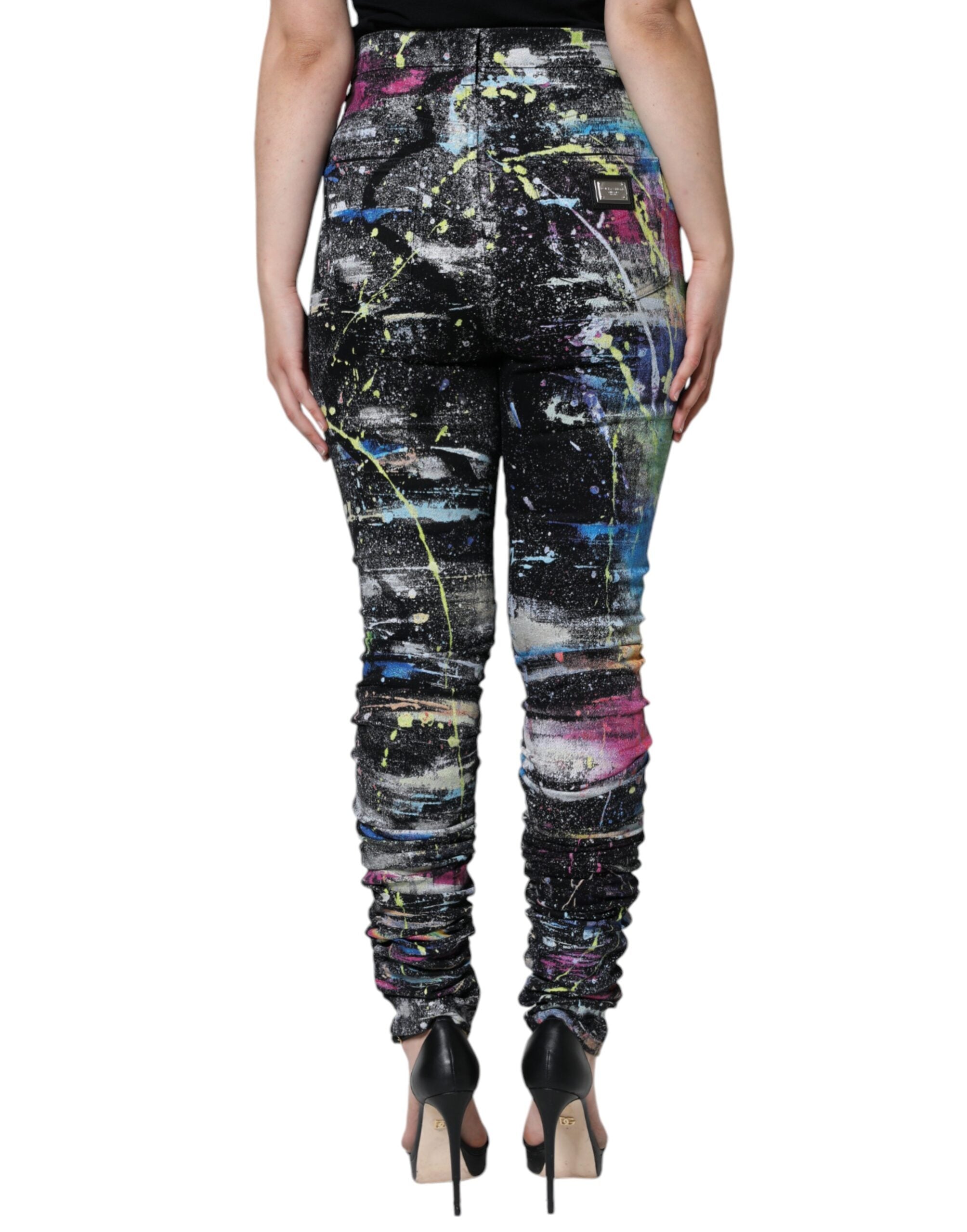 Jeans skinny en denim coton multicolore avec éclaboussures de peinture, Dolce & Gabbana, style moderne et artistique.
