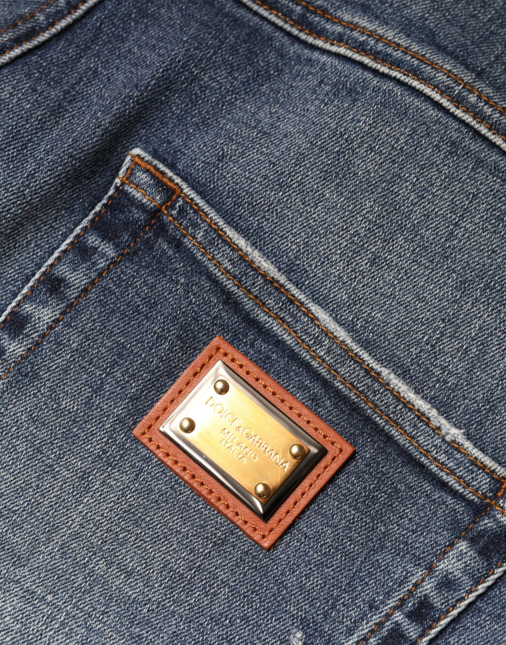 Jeans skinny en denim coton bleu foncé tacheté de Dolce & Gabbana, look décontracté avec détails usés.