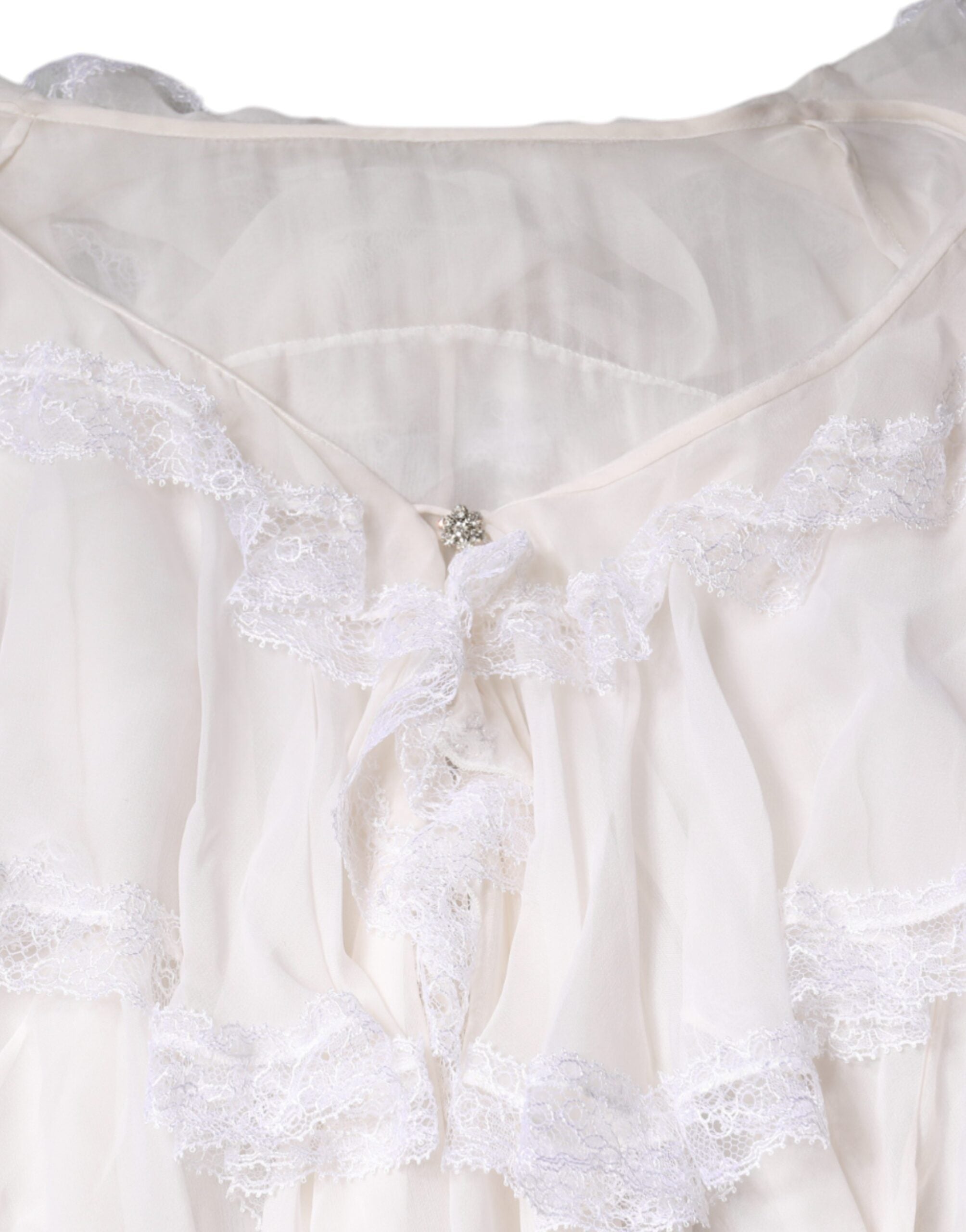 Chemisier blanc à manches longues Dolce & Gabbana avec volants en dentelle, élégant et féminin.