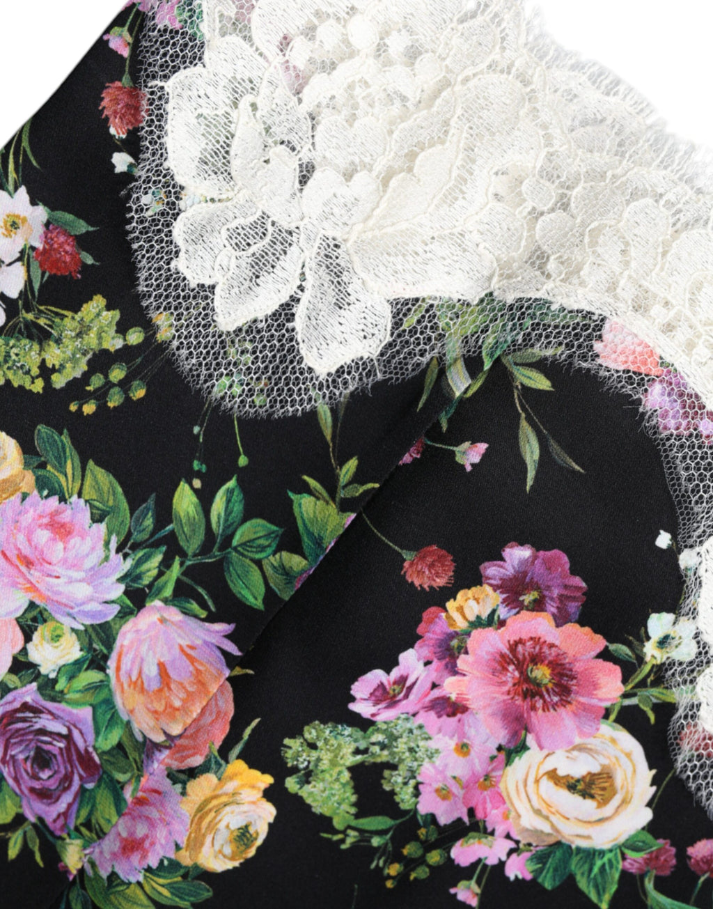 Blouse Dolce & Gabbana en dentelle noire à manches courtes avec motifs floraux, élégante et féminine.
