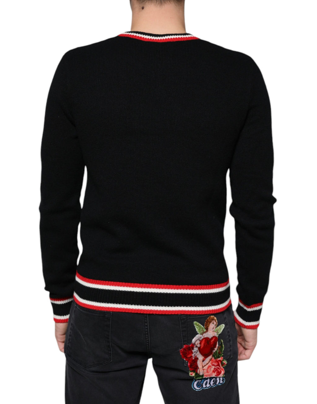 Pull Dolce & Gabbana en cachemire noir avec motif de cochon, style élégant et luxe visible dans le design.