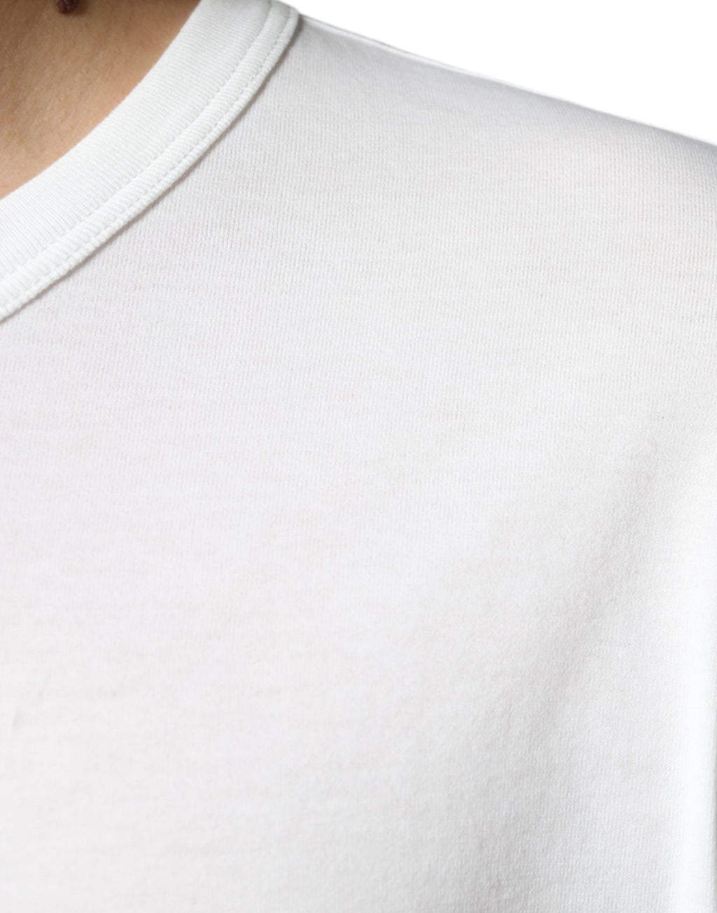 T-shirt blanc en coton Dolce & Gabbana avec logo embossé, col rond et design élégant visible sur l'image.
