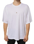 T-shirt blanc en coton Dolce & Gabbana avec logo en métal DG à manches courtes, style élégant et moderne.