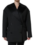 Manteau noir en polyester Dolce & Gabbana, à double boutonnage, longueur mi-saison, avec col classique et poches latérales.