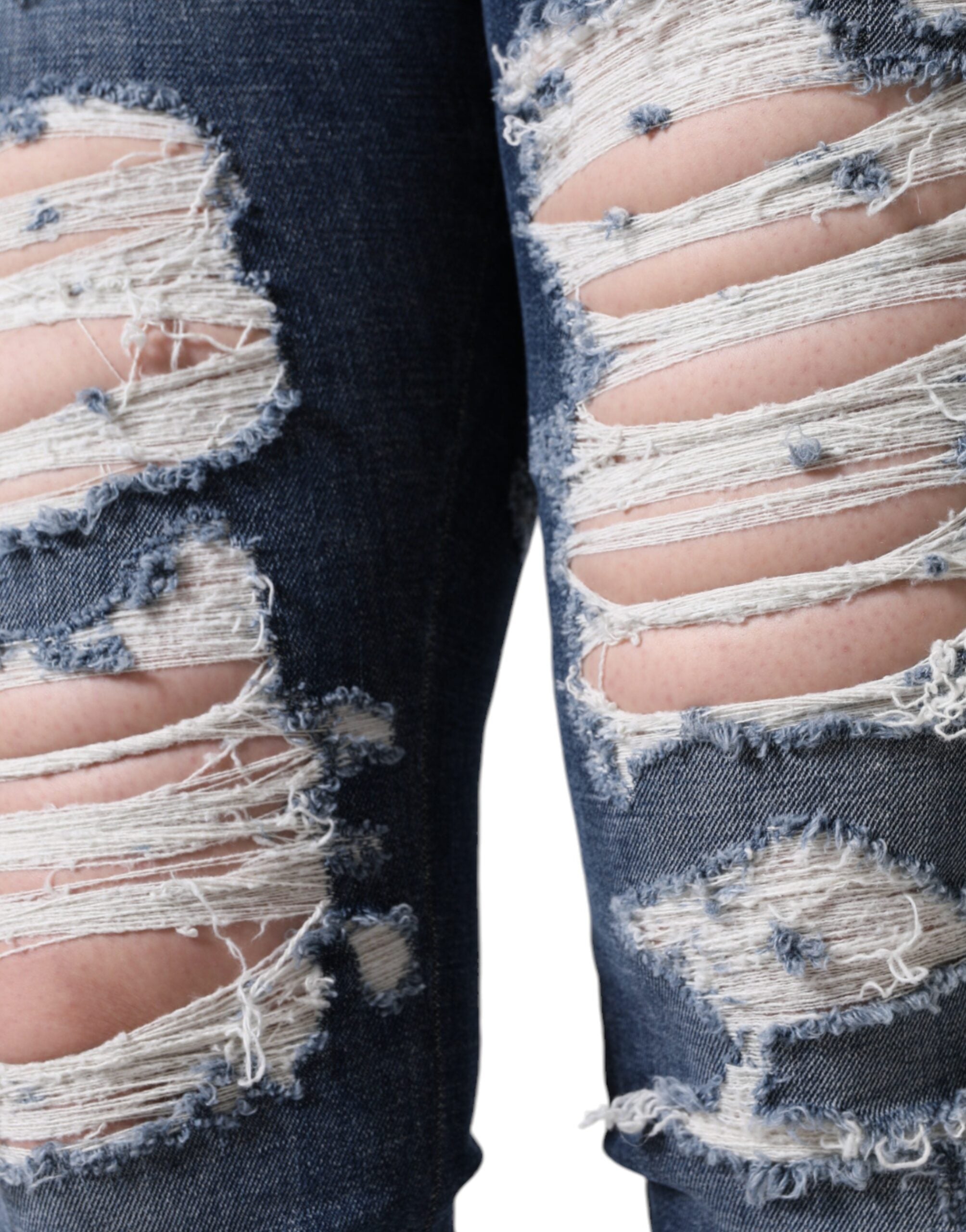 Jeans skinny en coton stretch bleu Dolce & Gabbana avec déchirures, coupe tordue et style décontracté.