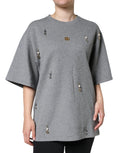 T-shirt gris en coton mélangé Dolce & Gabbana avec embellissements, vue de face, détails du tissu et décoration visibles.