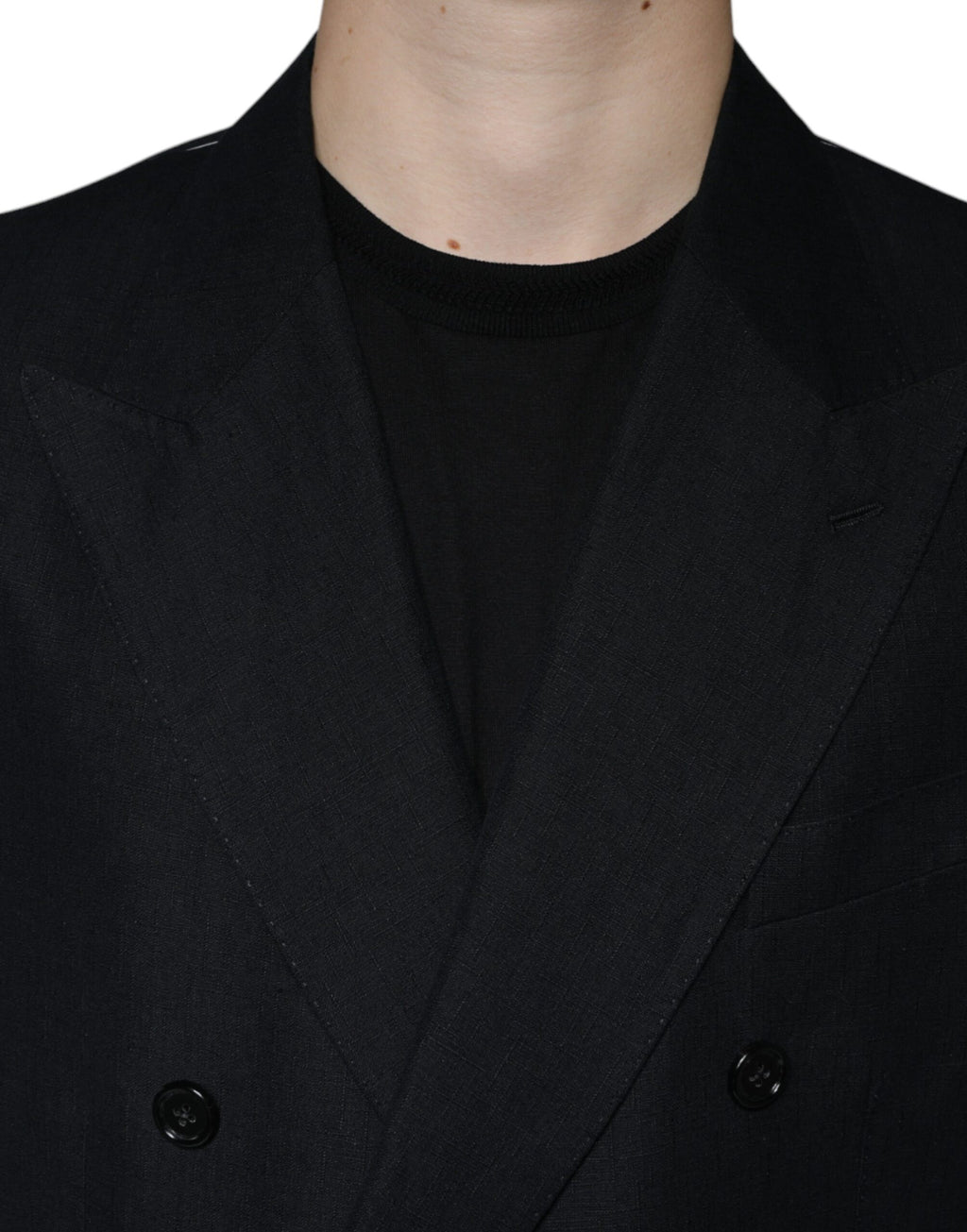 Veste blazer noire en lin à double boutonnage Dolce & Gabbana, élégante et structurée, portée sur un fond blanc.