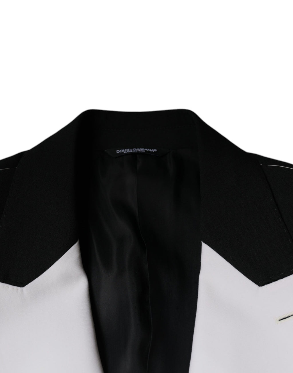 Veste blazer Dolce & Gabbana noire et blanche à un bouton, coupe classique, portée élégante, visible sur l'image.