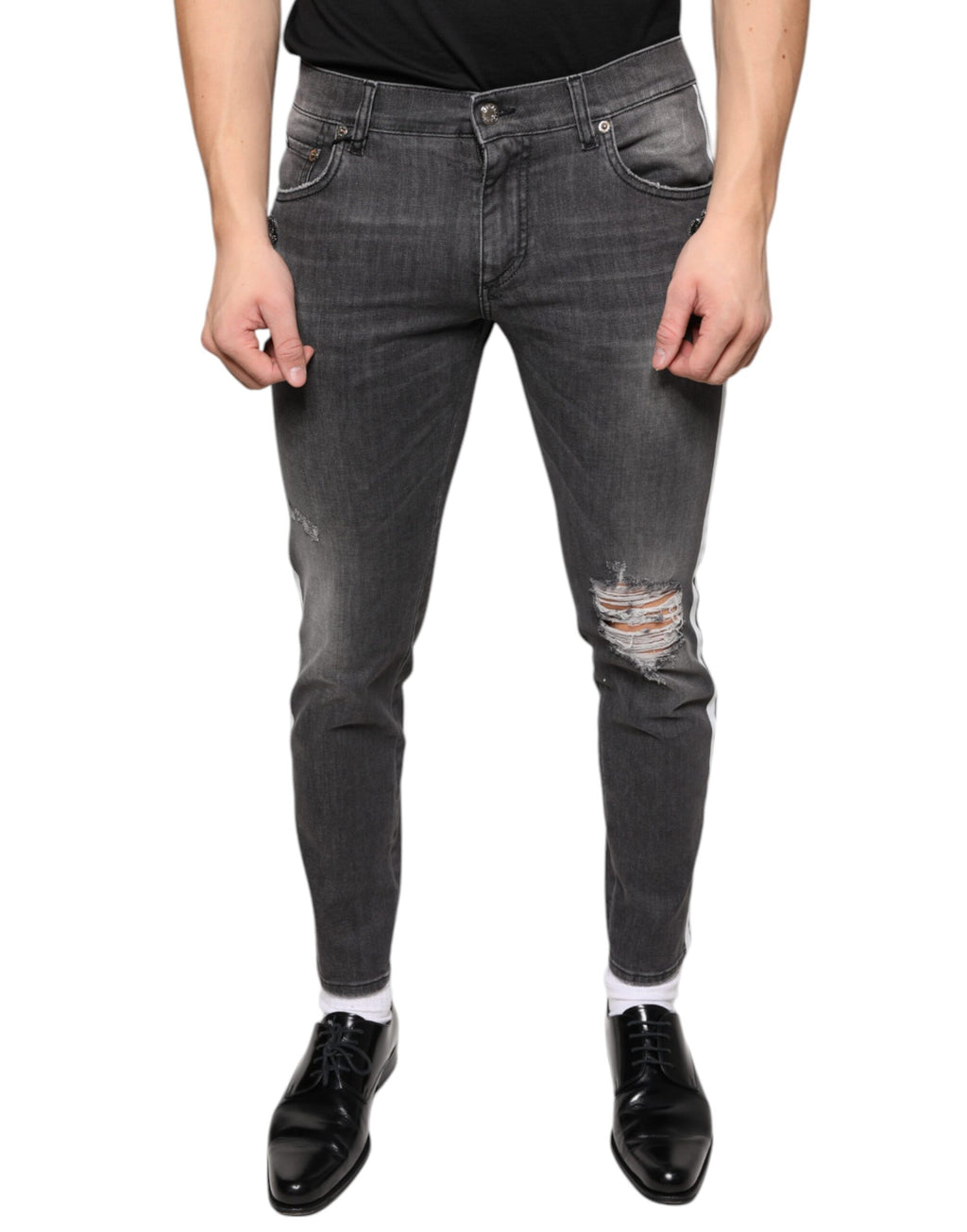 Jeans slim en coton noir déchiré de Dolce & Gabbana pour homme, style denim avec détails usés et coupe ajustée.