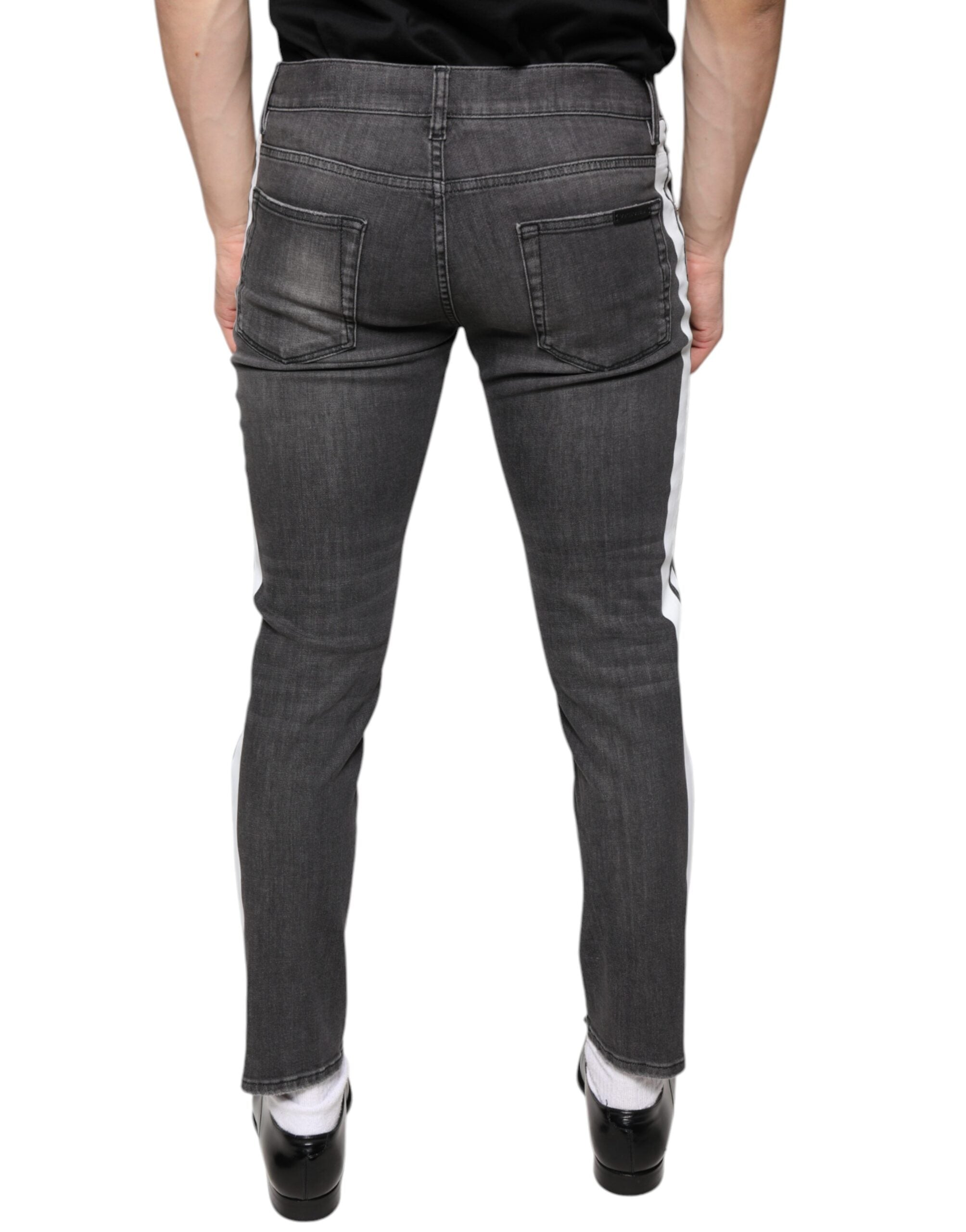 Jeans pour hommes Dolce & Gabbana en coton noir déchiré, coupe skinny, denim tendance avec détails usés.