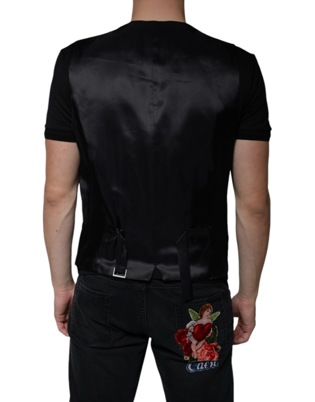 Gilet noir en laine Dolce & Gabbana, robe veste formelle élégante, détail ajusté et finition soignée, porté dans un style sophistiqué.