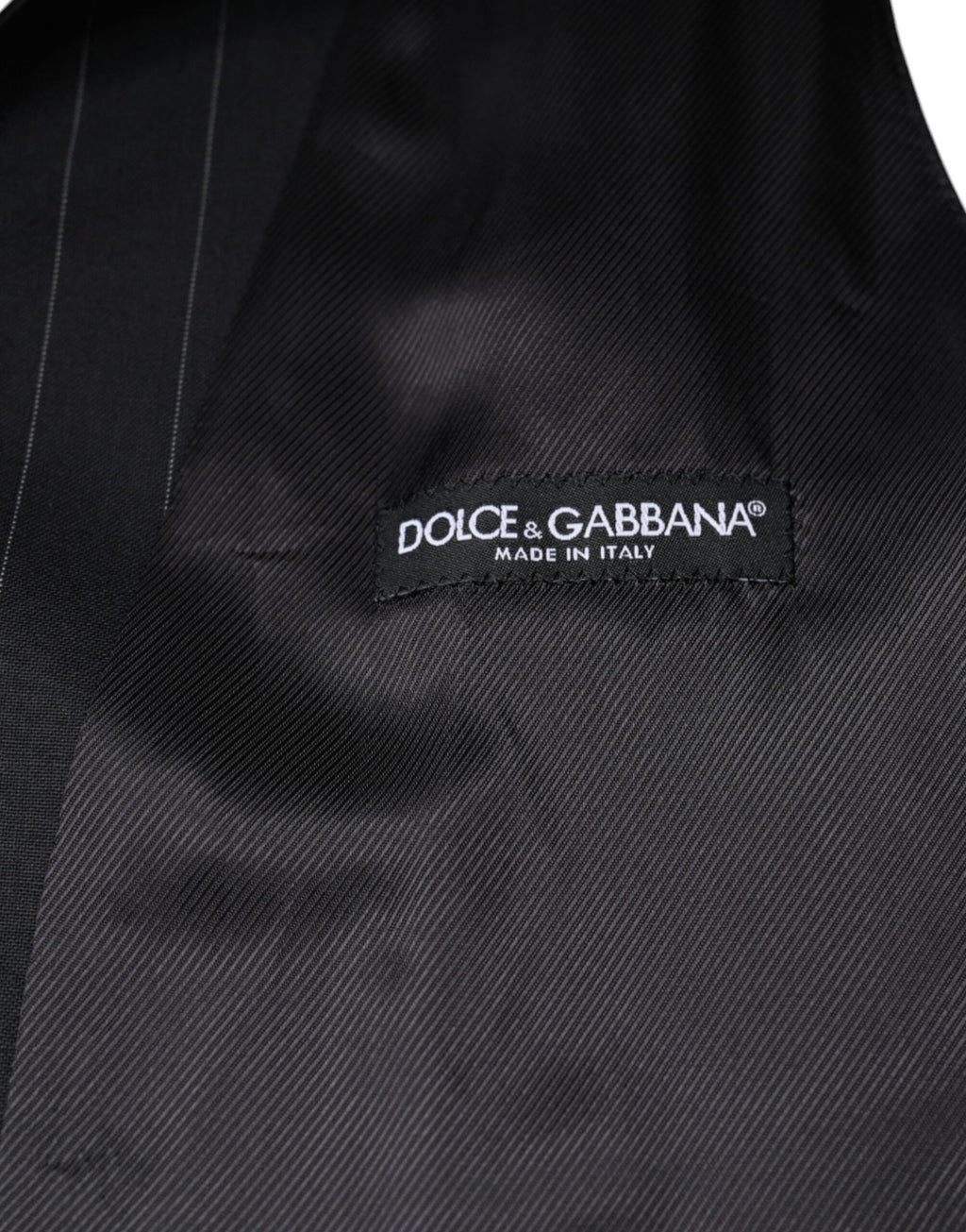 Robe portefeuille en cuir noir Dolce & Gabbana, veste formelle élégante pour femme, détail en cuir et coupe sophistiquée.