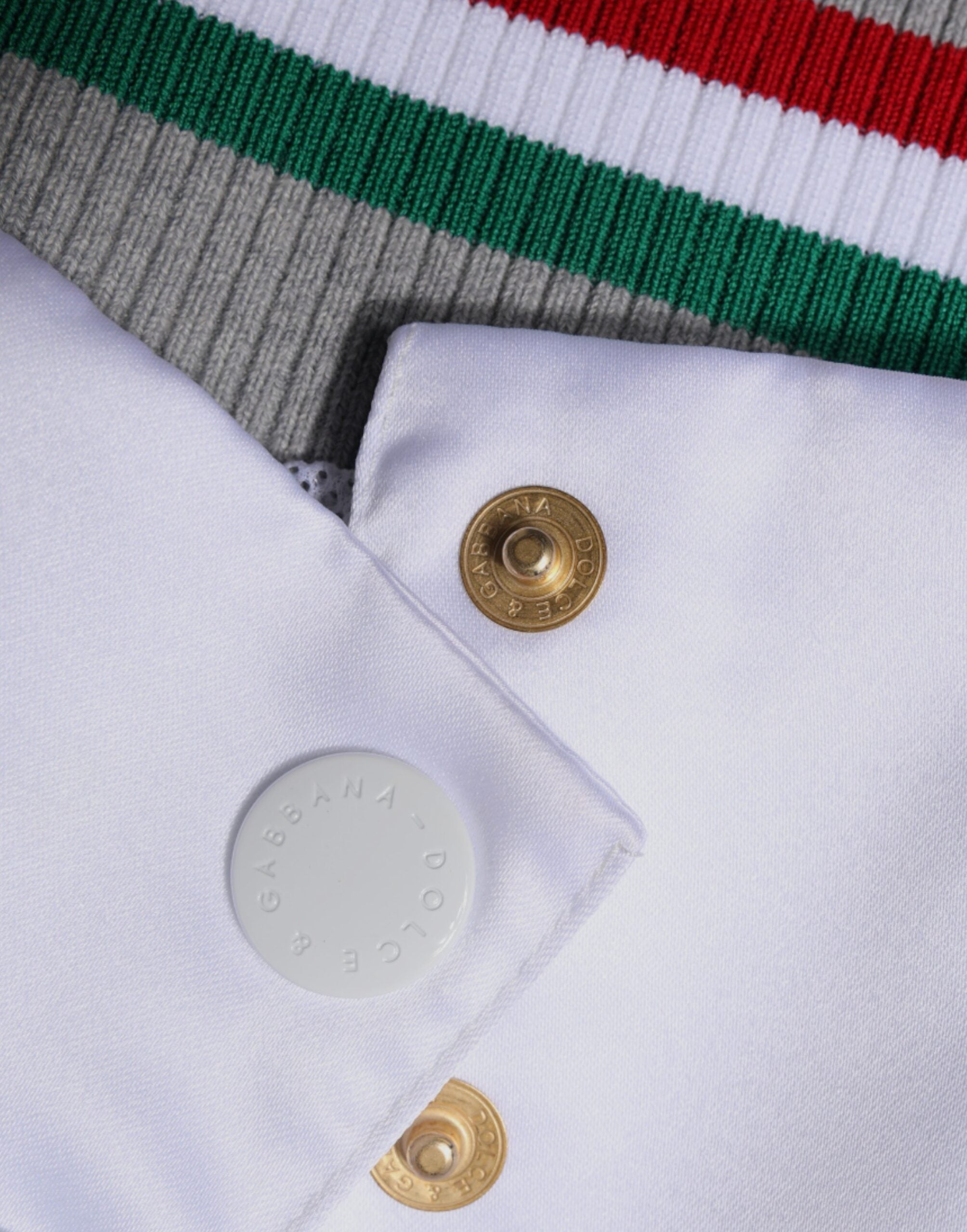 Veste bomber à boutons multicolores Dolce & Gabbana, style Italia, en tissu léger avec détails colorés.