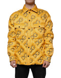 Veste matelassée jaune Dolce & Gabbana avec logo, boutons et design élégant, vue de face sur fond neutre.