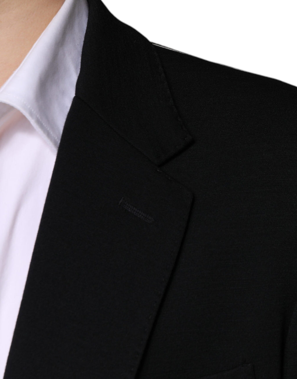 Veste formelle noire en laine Dolce & Gabbana à fermeture simple, élégante et ajustée, portée sur un mannequin.