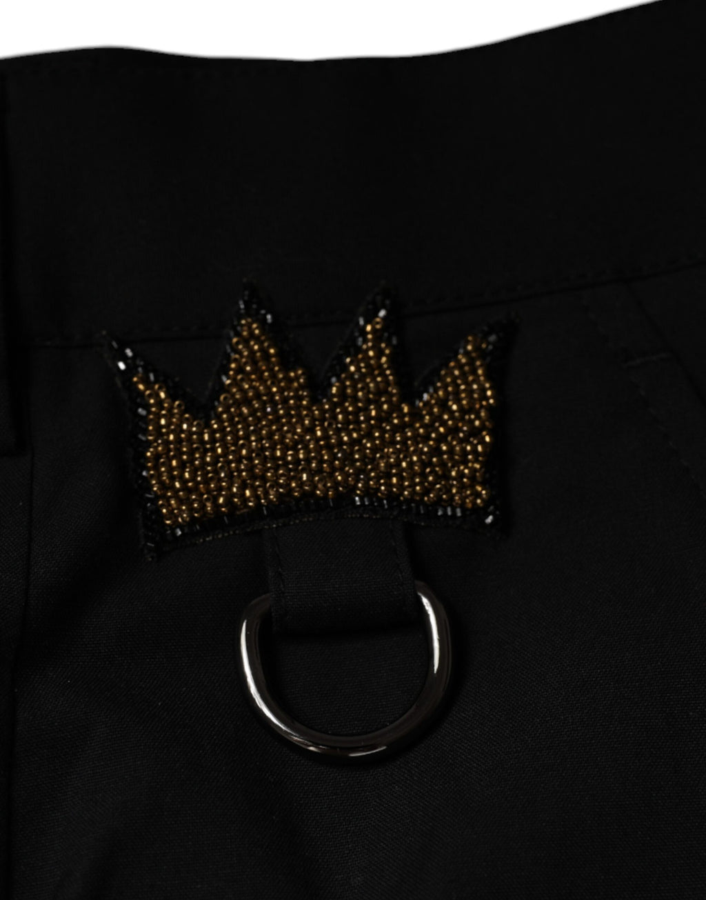 Pantalon en coton noir Dolce & Gabbana avec motif couronne, élégant et sophistiqué, idéal pour une tenue chic et moderne.