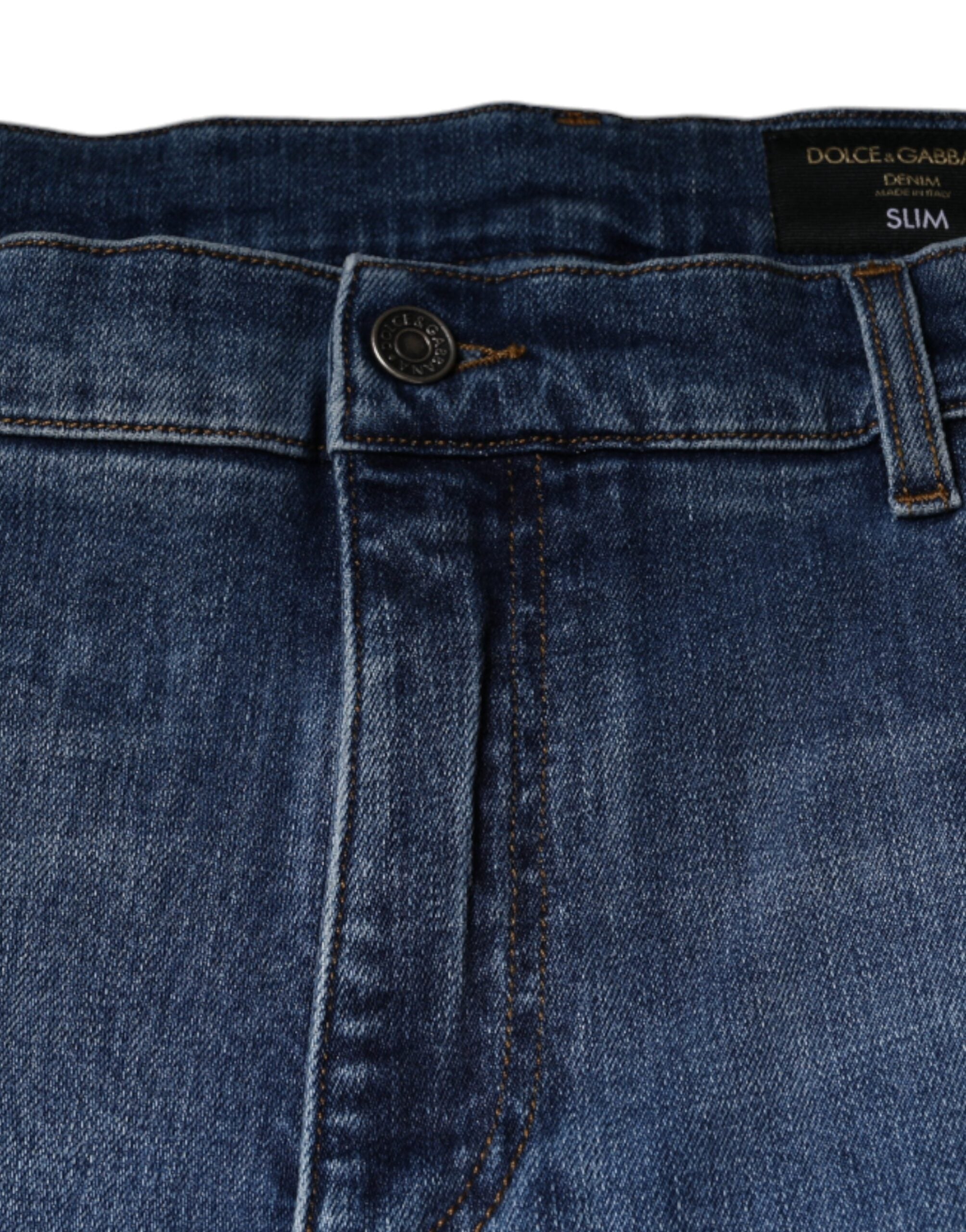Jeans pour homme Dolce & Gabbana en coton délavé bleu, coupe stretch et denim, visibles avec détails de couture et fermeture éclair.