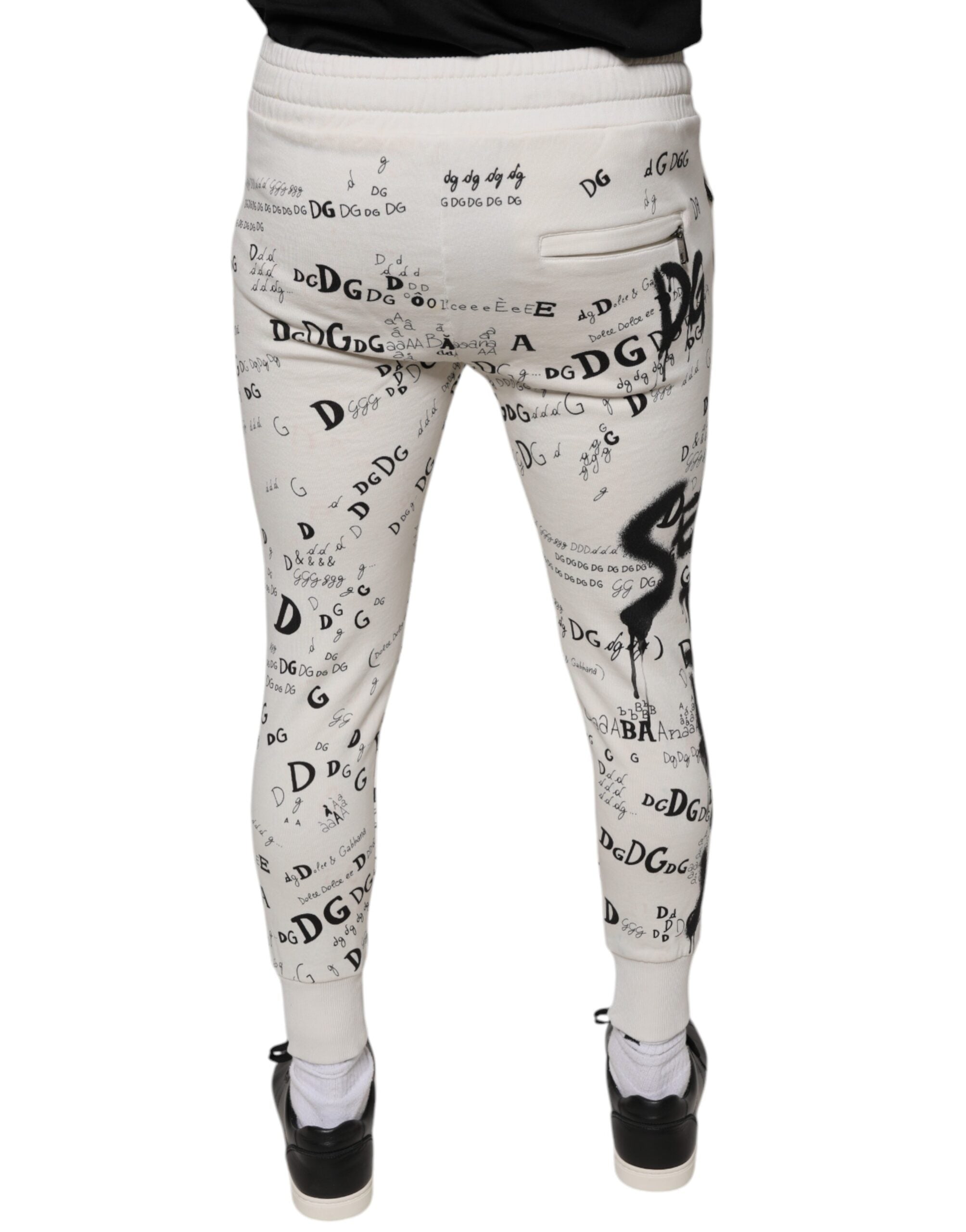 Pantalon jogger en coton blanc imprimé de Dolce & Gabbana, style décontracté avec tresse et détails élégants.