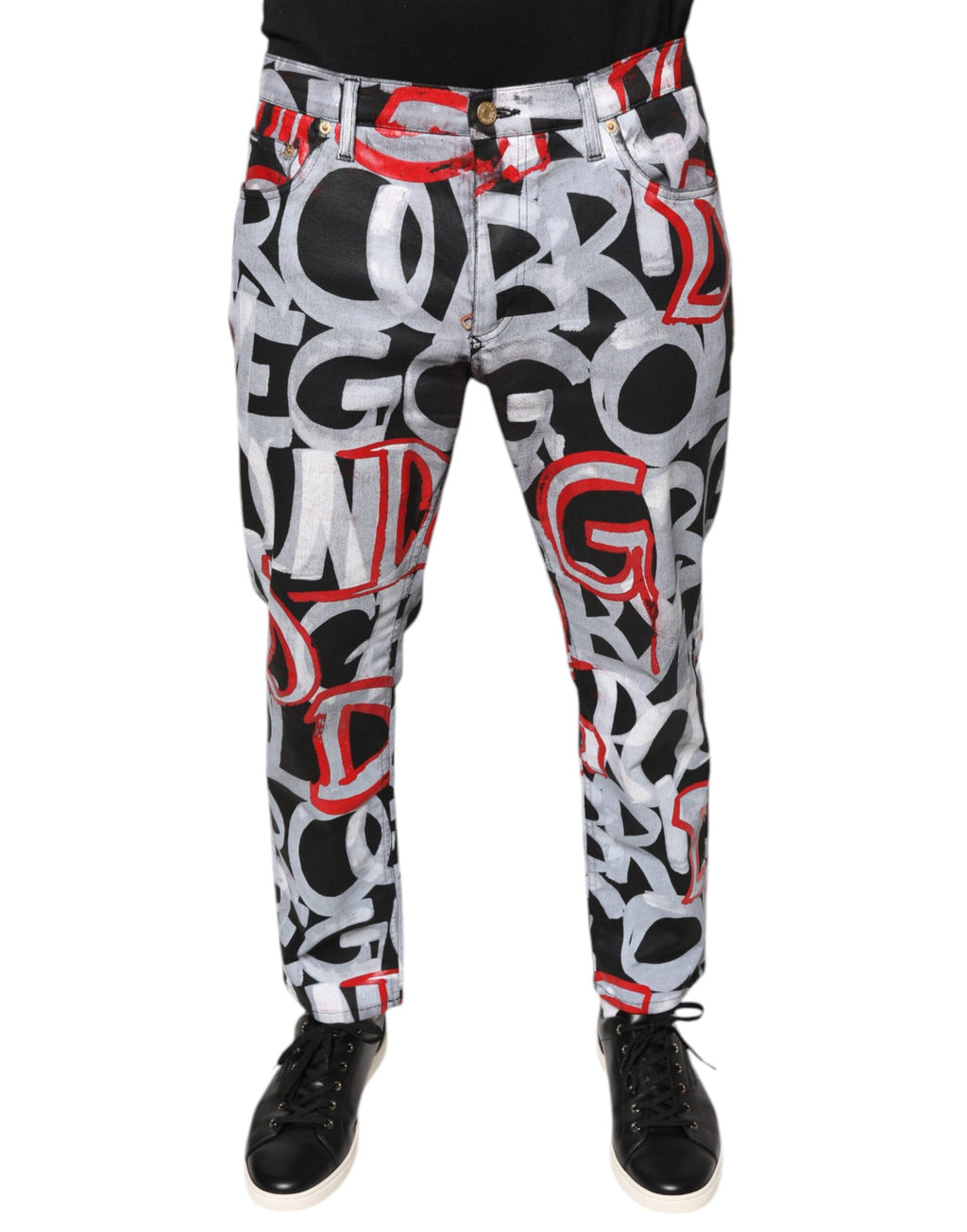 Jeans skinny en denim multicolore en coton Dolce & Gabbana avec monogramme, visibles en détail dans l'image.