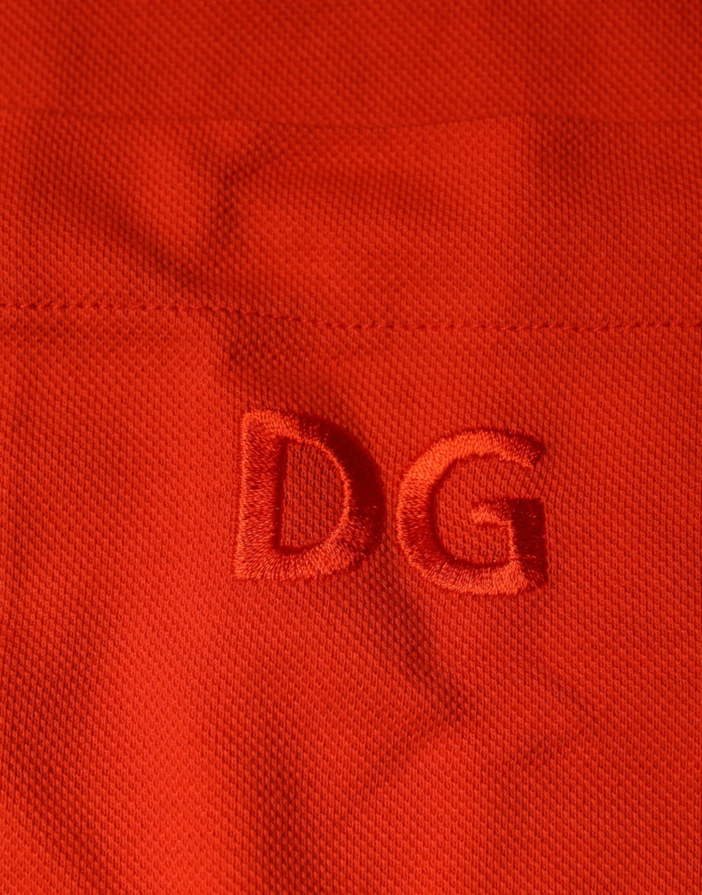 Chemise polo Dolce & Gabbana en coton orange à boutons, style décontracté et élégant, vue de face.
