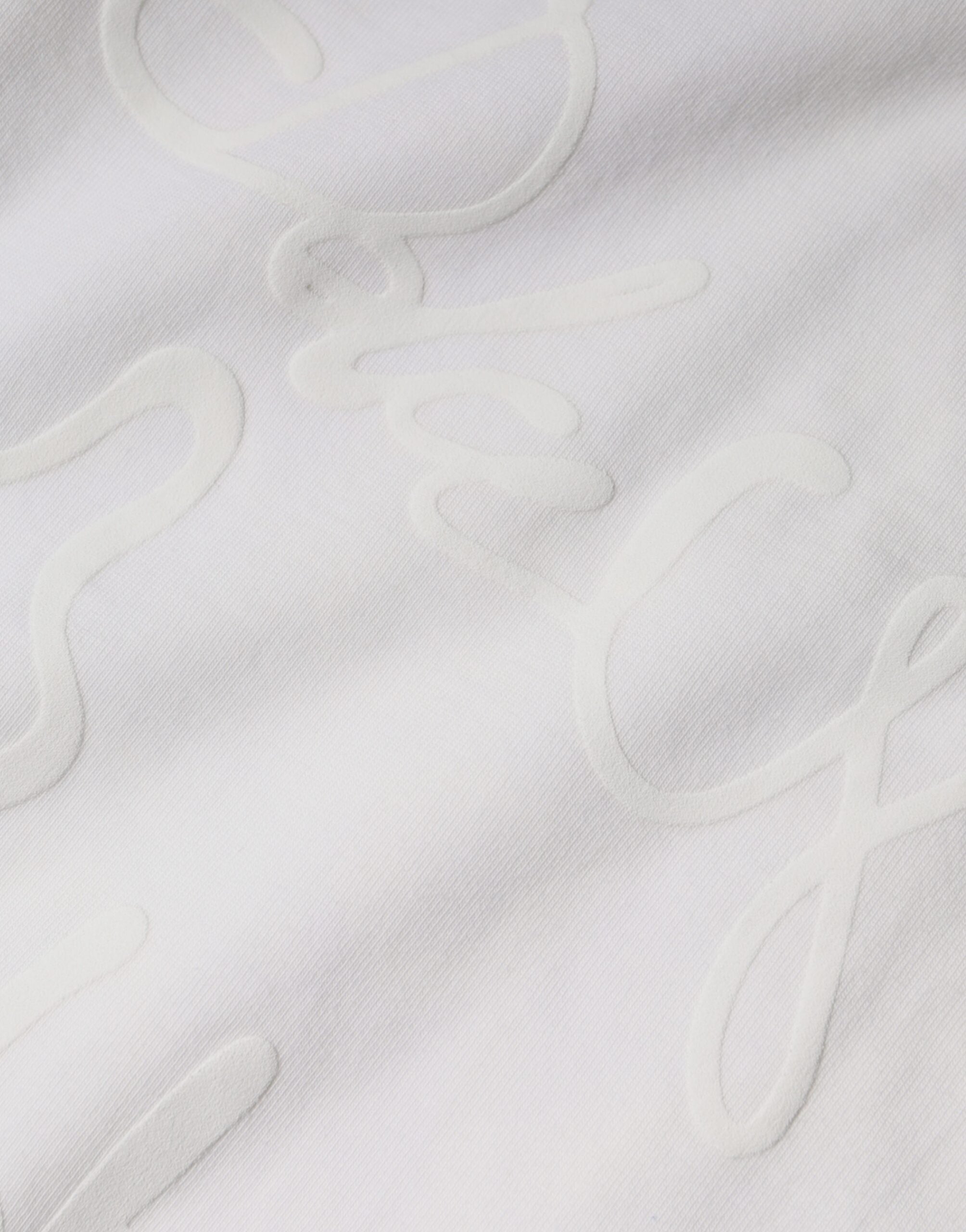 T-shirt blanc en coton Dolce & Gabbana avec logo imprimé, col rond, style décontracté, visible en gros plan.